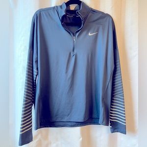 Running long sleeve shirt with reflective accents. Nike pewter/blue in color